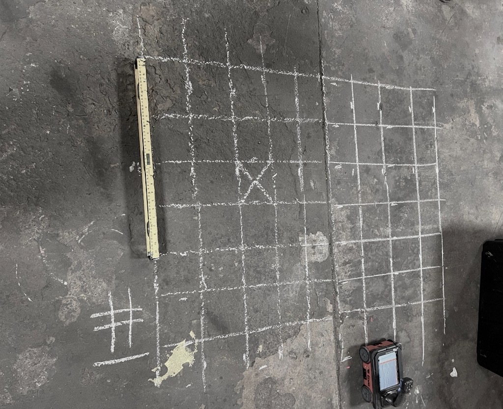 Photo of concrete floor with markings from GPR discovery.